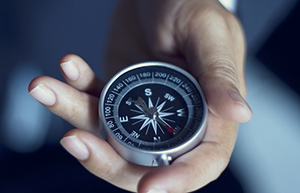 Businessman with a compass holding in hand